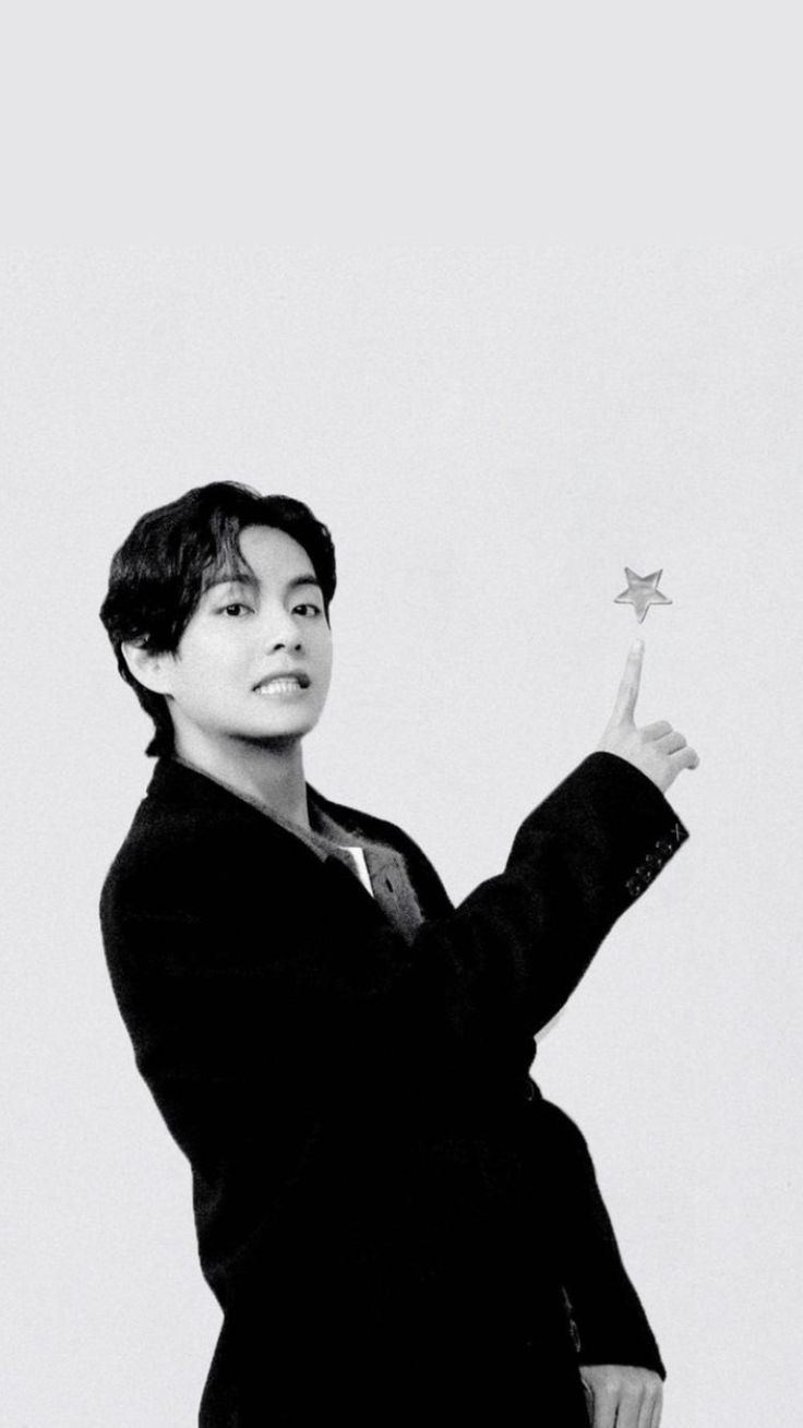 a young man holding a star in his right hand