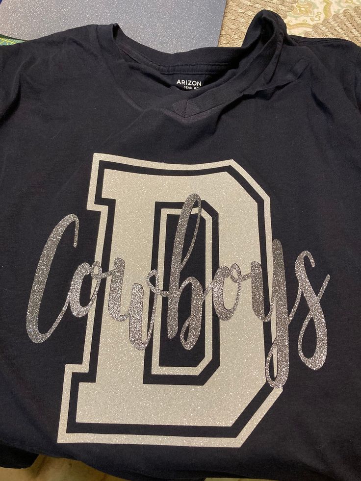 "This is a listing for a finished product. Dallas Cowboys Tee (shirt) with a \"D\" and \"Cowboys\" on the letter \"D\". The image runs about 12 inches tall and about 11 inches wide. It is made to order and is made with glitter heat transfer vinyl. The size of the image is adjusted based on the size of the shirt.  Item is made in a smoke free home. Made to order. It is packaged in a clear bag to keep its shape. It comes with garment instructions and thank you card. The tee is shipped in a white o Dallas Cowboys Shirts Vinyl Women, Dallas Cowboys Shirt Ideas, Dallas Cowboys Shirts Vinyl, Cowboys Outfits, Dallas Cowboys Christmas, Dallas Cowboys Outfits, Cowboys Sweatshirt, Dallas Cowboys Sweatshirt, Dallas Cowboys Shirts