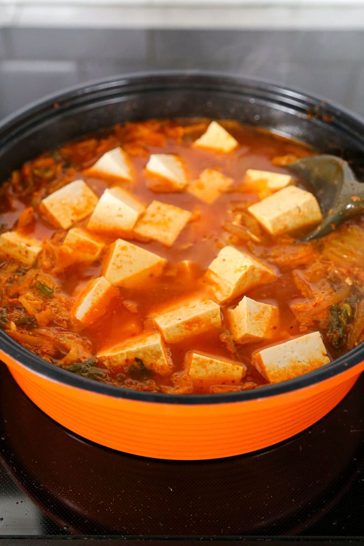 a pot filled with tofu and sauce on top of a stove