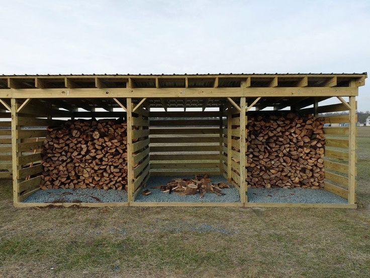 a large pile of wood sitting in the middle of a field