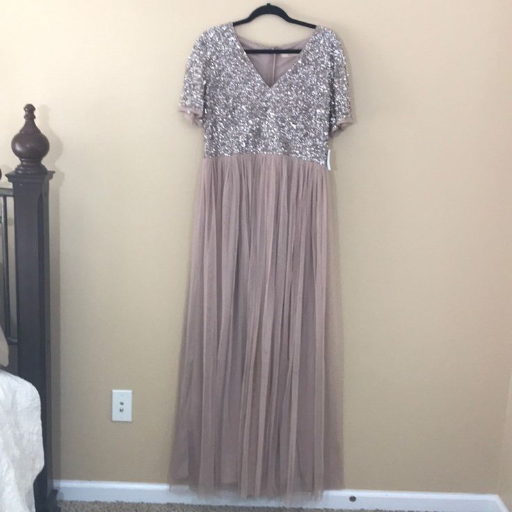 This Maya Deluxe Blush Maxi Dress Is A Beautiful Dress Perfect For A Wedding. Empire Waist.Vneck. Sequin Top. Short Sleeves. Tulle Bottom With Lining. New With Tags. Size 12. 100% Polyester. Length: 60in. Bust: 18in. Arm Length: 8in. Sequin V-neck Evening Dress For Mother Of The Bride, Glamorous Short Sleeve Maxi Dress For Wedding, Short Sleeve Sequined Maxi Dress For Wedding, Glamorous V-neck Dress For Mother Of The Bride, Elegant Silver Bridesmaid Evening Dress, Embellished Short Sleeve Maxi Dress For Wedding, Short Sleeve Embellished Maxi Dress For Wedding, Embellished Maxi Dress With Short Sleeves For Wedding, Embellished Short Sleeve Maxi Wedding Dress