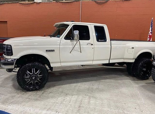 a white pickup truck parked in a garage