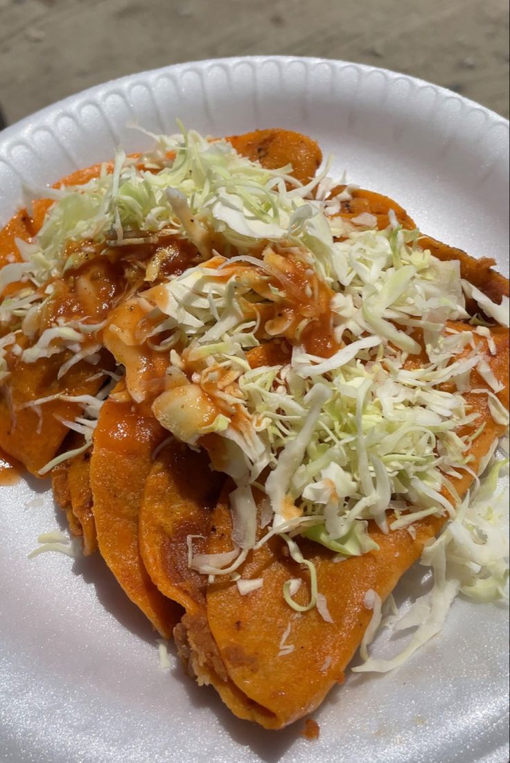 some food is sitting on a paper plate