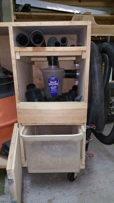 an open cabinet with several different types of tools in it, including a vacuum and other items