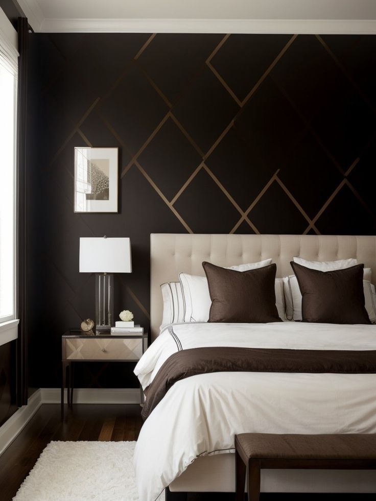 a bedroom with black walls, white bedding and brown accents on the headboard