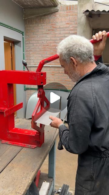 an older man is working on a machine