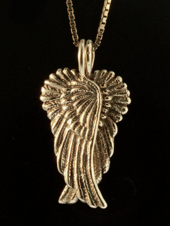 Two separate and detailed Angel Wings hang from a single chain. Each 14k gold wing is 1 1/8" high and 7/16" wide. Notice how when hung together, they form the shape of a heart? Wear them together, or wear one and gift one of the Wings to a significant other in your life. The gold chain is not included in the price. If you would like a solid 14k gold chain please select the stye and length from the option menu. If you would prefer a different style or length please contact us.All Marty Magic Jewe Gold Wing-shaped Sterling Silver Necklace, Gold Winged Sterling Silver Jewelry, Elegant Winged Gold Jewelry, Elegant Gold Winged Necklace, Elegant Gold Winged Jewelry, Antique Wheat Chain Jewelry Gift, Elegant 14k Gold Wing-shaped Jewelry, Angel Wing Pendant, Angel Wing Necklace