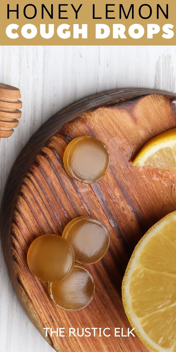 honey lemon cough drops on a wooden cutting board with sliced lemons and honey syrup