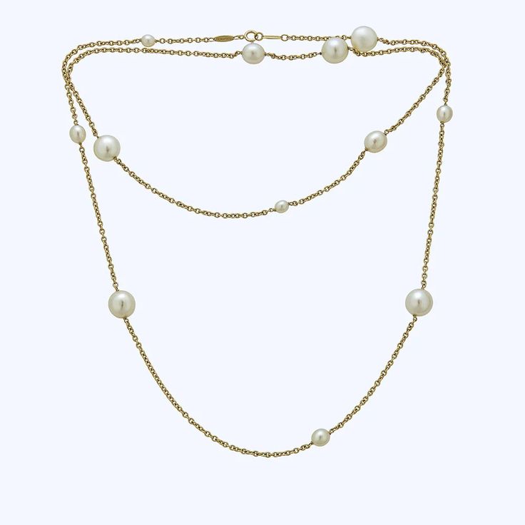 The Elsa Peretti Tiffany &amp; Co. Gold Pearl Chain is a classic and elegant necklace. It features two strands of fine gold chain, adorned with evenly spaced pearls of different sizes. This 34" long necklace is made of 18K yellow gold and pearls, giving it a contemporary and luxurious feel. The clasp mechanism allows f Luxury Long Pearl Chain Necklace, Elegant Double Strand Gold Pearl Necklace, Elegant Gold Double Strand Pearl Necklace, Luxury Pearl Chain Necklace For Wedding, Gold Double Strand Pearl Necklace For Formal Occasions, Elegant Pearl Necklace With Chain, Formal Gold Double Strand Pearl Necklace, Elegant Single Strand Chain Necklace For Formal Occasions, Elegant Pearl Drop Chain Necklace For Formal Occasions