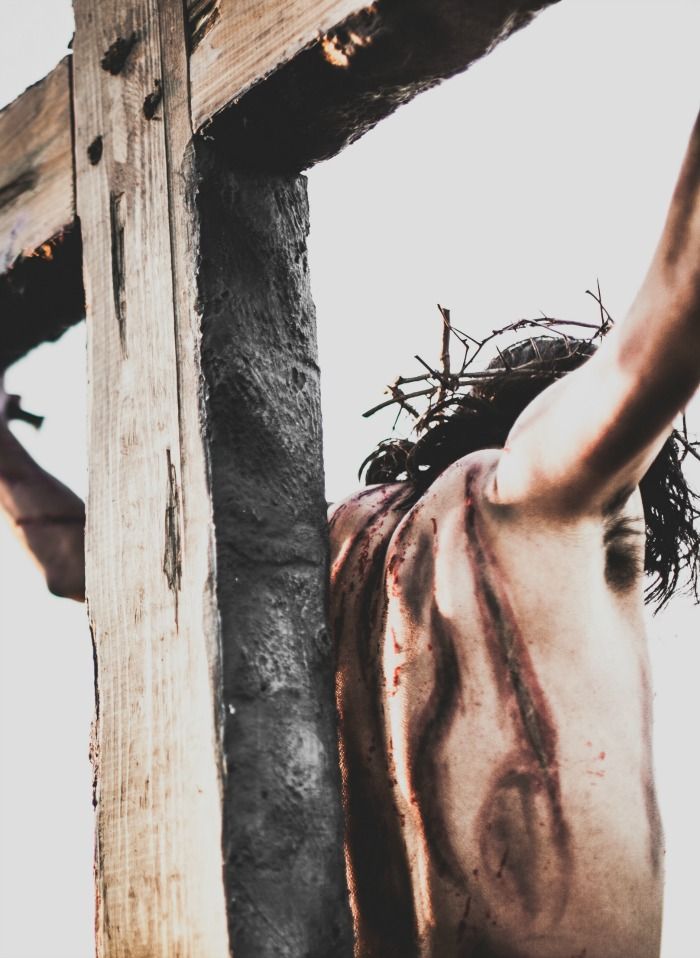 a man is nailed to the cross with his hands