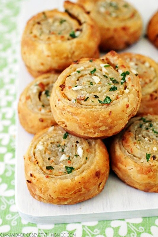 several small pastries on a white plate with green and white table cloth in the background