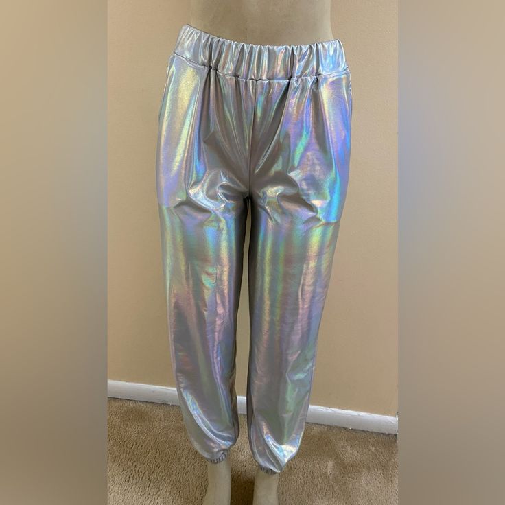 This Is A New Pair Of Iridescent Retro Looking Joggers With Pockets In A Size Small. Shiny Opalescent Silver Metallic Color, They Are Loose Fitting And Have Elastic Waist And Ankles Giving Off Those 1990s Club Vibes. Never Worn. Polyester/Cotton Blend. Measures: 12” Rise, 27” Inseam Clean, Pet And Smoke Free Home. Thank You! Metallic Disco Bottoms For Spring, Iridescent Disco Bottoms For Party, Metallic Stretch Casual Pants, Shiny Fitted Casual Bottoms, Casual Metallic Stretch Pants, Iridescent Fitted Disco Bottoms, Casual Shiny Metallic Bottoms, Casual Metallic Bottoms With Elastic Waistband, Casual Metallic Pants For Night Out