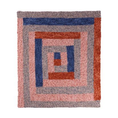 an orange, blue and pink rug with squares on it's sides is shown