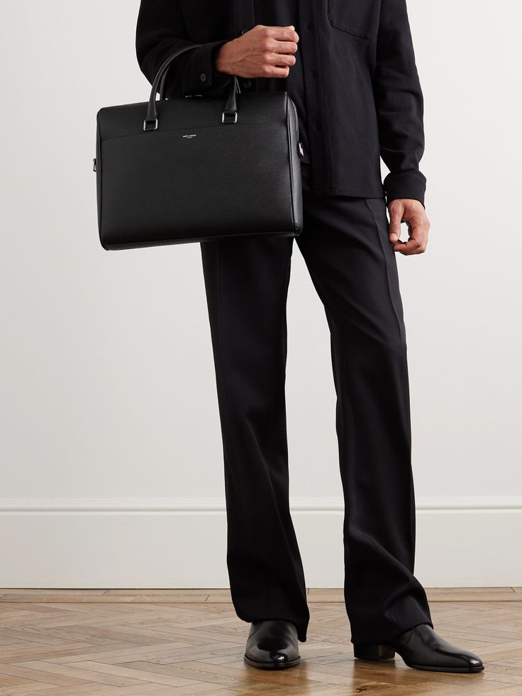 SAINT LAURENT's briefcase is a refined classic that's been perfected over the decades. Crafted from black full-grain leather, it has a structured silhouette that's smart and sleek. Use it to elevate your workwear repertoire. Elegant Textured Leather Briefcase For Workwear, Elegant Textured Leather Briefcase For Work, Black Saffiano Leather Briefcase For Work, Saffiano Leather Briefcase With Palladium Hardware For Business, Saffiano Leather Briefcase With Palladium Hardware, Designer Textured Leather Briefcase For Work, Designer Leather Briefcase For Business, Designer Textured Leather Briefcase For Business, Designer Leather Briefcase For Business Meetings