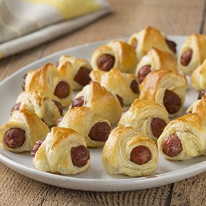 a white plate topped with pigs in a blanket