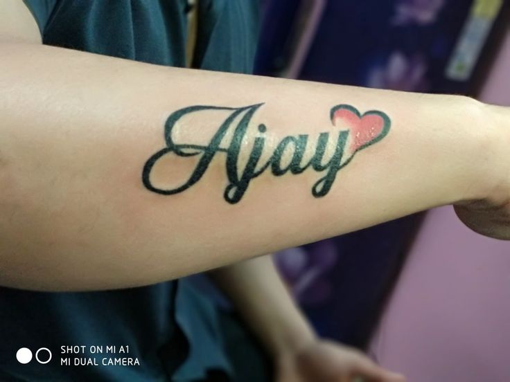 a person with a tattoo on their arm that says, ahay? and hearts