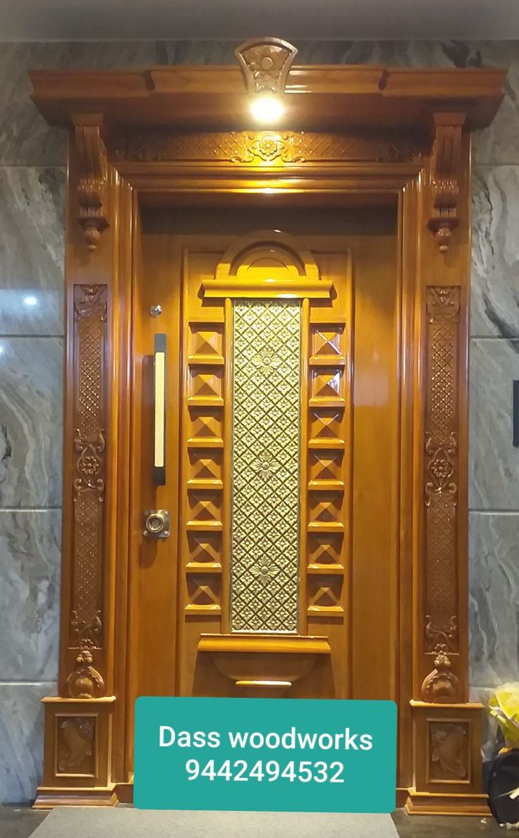 an ornate wooden door with the words daas wood works on it