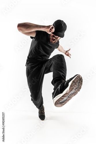 a young man jumping in the air with his foot up and wearing a black hat