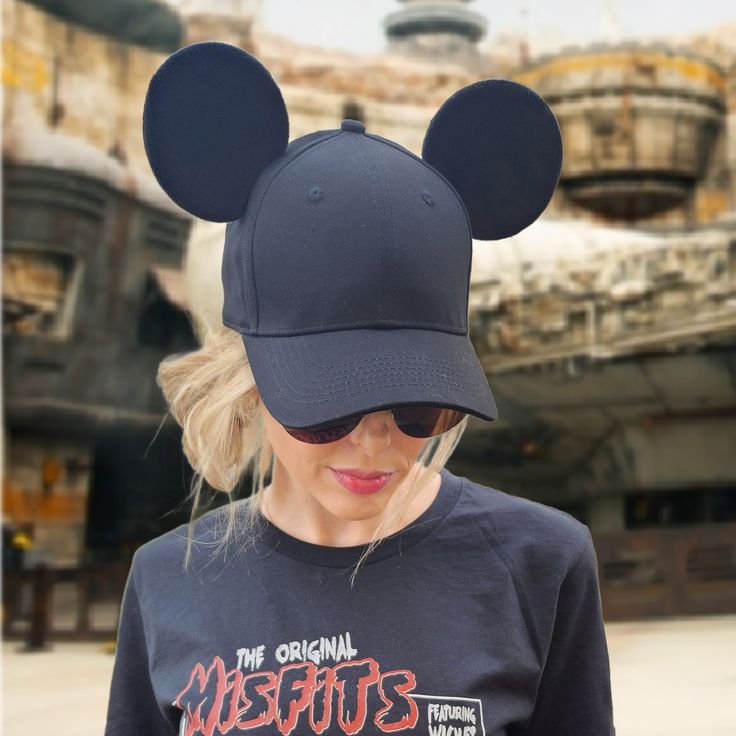 Our Classic Mouse Ear Hat is perfect for a day spent in the Disney parks or out around town. This hat is made of 100% high quality cotton to be both lightweight and durable. It features two premium black mouse ears made to stand up... even on the wildest rides! Details: ONE SIZE FITS MOST ADULTS: Ball cap features an adjustable metal slider on the back of the hat to allow for easy resizing for a snug and comfortable fit 100% COTTON excluding decoration: Adjustable hat is composed of lightweight and durable cotton fabric, and features a curved brim for protection from the sun. SPOT TREAT ONLY: Recommended for spot treatment only. Lay flat to dry. Do not iron decoration. Sun Spot, Ear Hat, Black Mouse, Ponytail Hat, Iron Decoration, Ear Hats, High Ponytails, Mouse Ears, Ball Cap