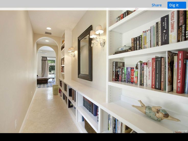 a long hallway with bookshelves filled with lots of books