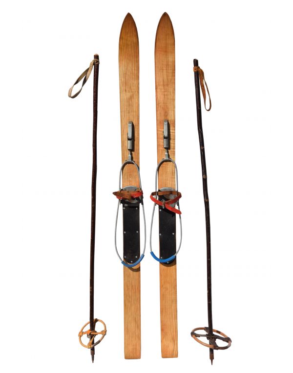 two skis and poles attached to the back of each other with straps on them