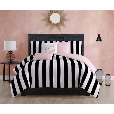 black and white striped bedding with pink accents