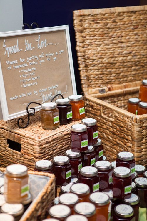 jars of honey sit in front of a sign that says spread the love on it