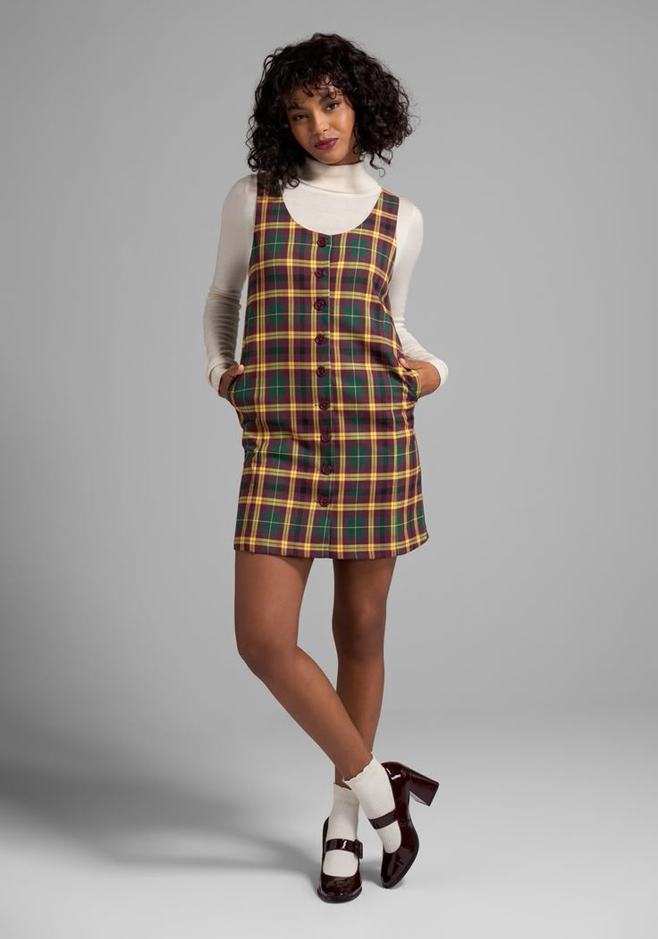 In an exclusive plaid print made up of rich and earthy tones of mustard, hunter green, and burgundy, you can’t get more retro than this fully-lined shift dress from our ModCloth namesake label ! Made from a stretchy woven fabric, this sleeveless shift dress boasts front button-up closure, a curved V-neckline and a fabulous flared hemline at the knee-length skirt. The classic relaxed silhouette is perfect from adding warm layers in the colder months, and this easy A-line looks fresh and playful w Late 60s Womens Fashion, 90s Fall Outfits Plus Size, Mod Dress Outfit, 80s Dress Outfit, Modern 60s Outfits, 60s Outfits For Women, Holiday Casual Outfits, 1960s Inspired Outfits, 70s Style Dress