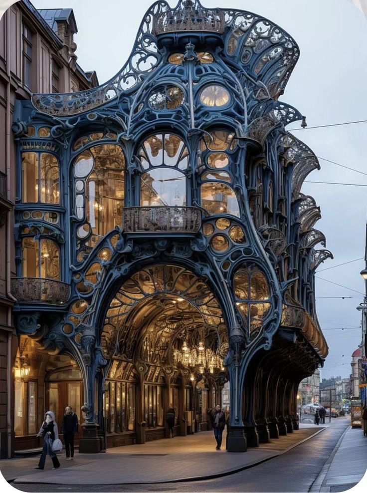 an ornate building on the corner of a city street with people walking by it at dusk