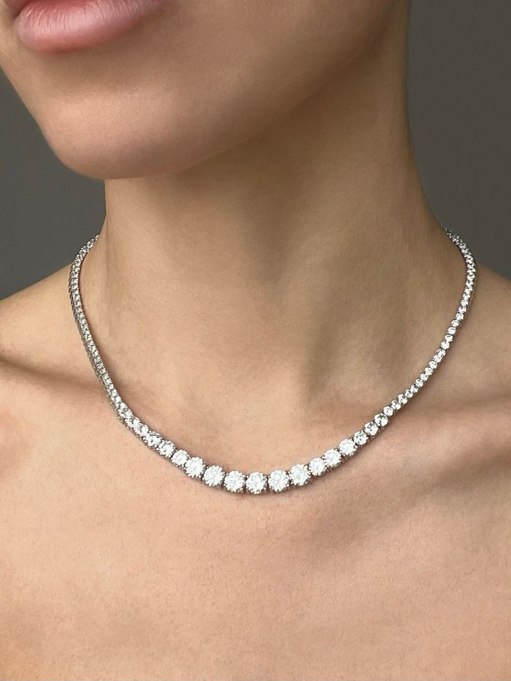 Adorn yourself with the ultimate luxury with this Graduated Tennis Necklace. Each piece is carefully and expertly crafted from solid 925 sterling silver, and adorned with shimmering created diamonds totaling 16.32tcw for a stunning and unforgettable finish. Whether you choose Sterling silver tone, 14k yellow gold tone or 14k rose gold tone, you will stand out with this elegant and sophisticated necklace. Perfect for weddings, or any special occasion. Our created diamonds and gemstones are synthe Timeless Sterling Silver Tennis Necklace, Timeless Sterling Silver Tennis Necklace With Round Cut, Timeless Sterling Silver Diamond Cut Tennis Necklace, Luxury Silver Tennis Necklace Gift, Timeless Formal Jewelry With Vvs Clarity, Fine Jewelry Silver Tennis Necklace With Diamond Cut, Silver Diamond Cut Tennis Necklace Gift, Fine Jewelry Sterling Silver Tennis Necklace, Fine Jewelry Silver Tennis Necklace