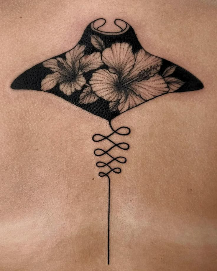 a manta ray with flowers on it's back and side tattoo designs for men