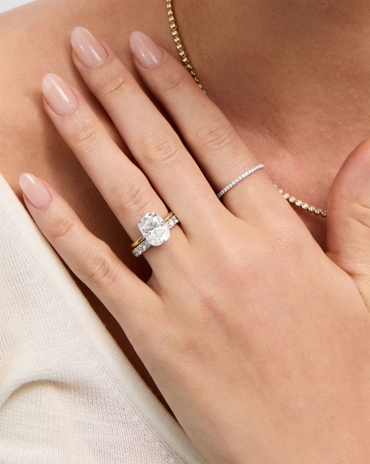 a woman's hand with a diamond ring on it