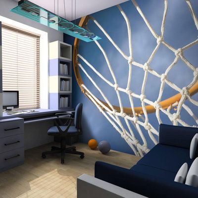 a room with a computer desk, chair and basketball net on the wall in it