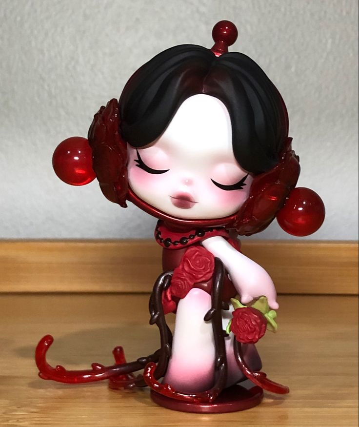 a small figurine is sitting on the floor with blood dripping all over it