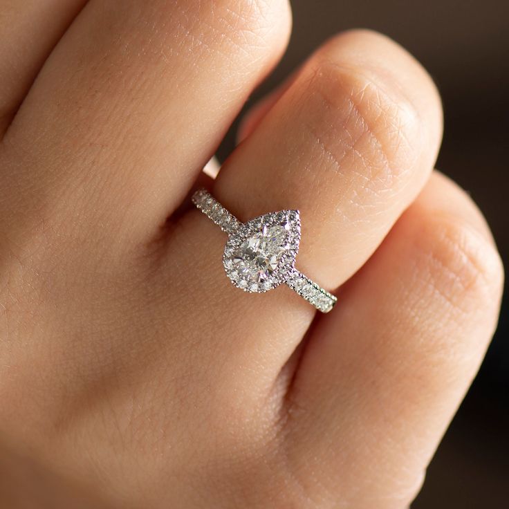 a woman's hand with a diamond ring on it