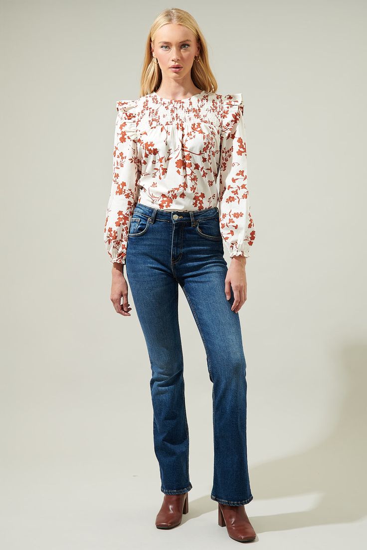 Kick off the season with the Garnet Floral Smocked Top! The beautiful rust floral design overlays white top with ruffles on shoulders followed by long bubble sleeves and an elastic cuff. Its smocked design gives it an extra touch of cuteness followed by a keyhole closure in the back. Perfect top to wear with some denim jeans.- Smocked- Ruffle details- Keyhole- Balloon long sleeves- Color: Rust MulSize + Fit - Model is 5'8" and wearing size XS- Measurements taken from size S - Chest: 21"- Length: Top With Ruffles, Smocked Top, Floral Midi Dress, Sweater Weather, Cotton Style, White Top, White Tops, Smocking, Best Sellers