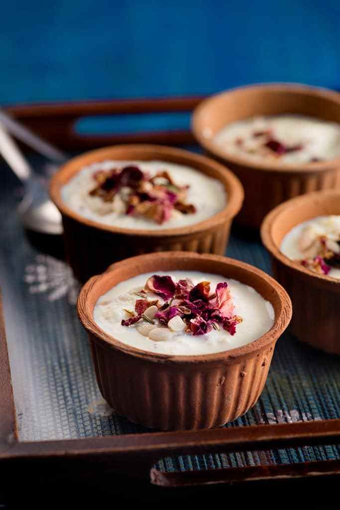 four small bowls filled with oatmeal and garnished with flowers