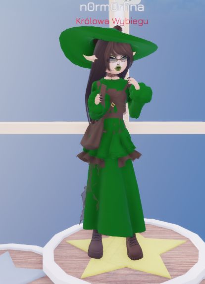 a woman in a green dress and hat standing on a star shaped platform with her hands behind her head