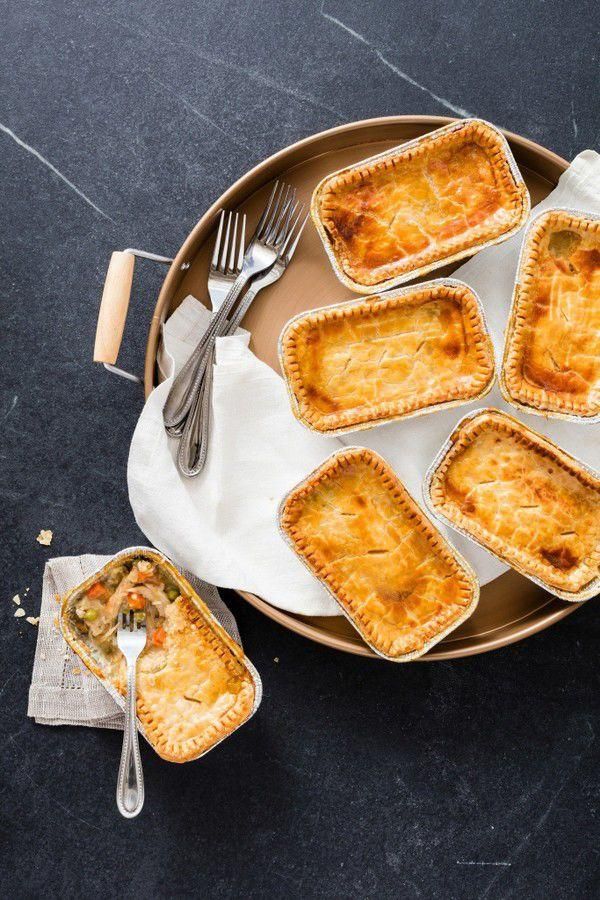 several small pies on a plate with forks