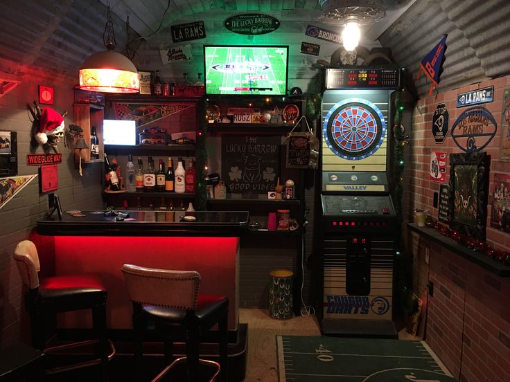 a room filled with lots of different types of games and lights on the wall above it