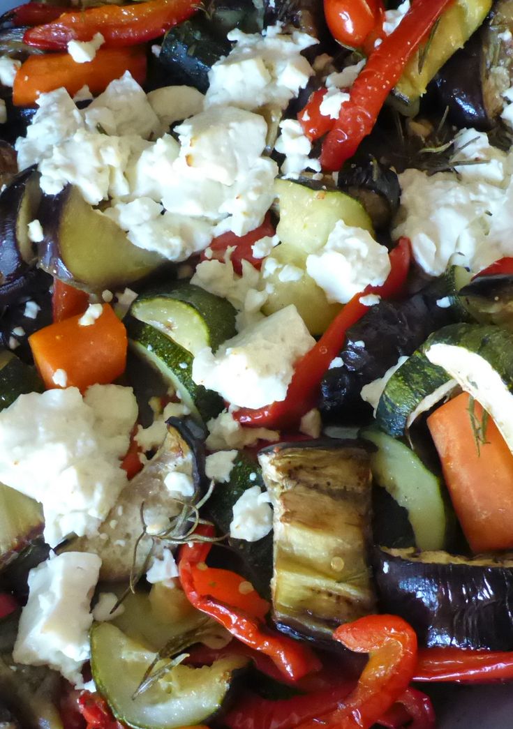 the vegetables are mixed together with feta cheese and other toppings on top of them