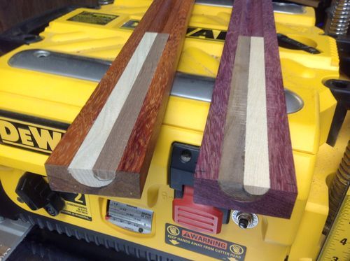 two pieces of wood sitting on top of a machine