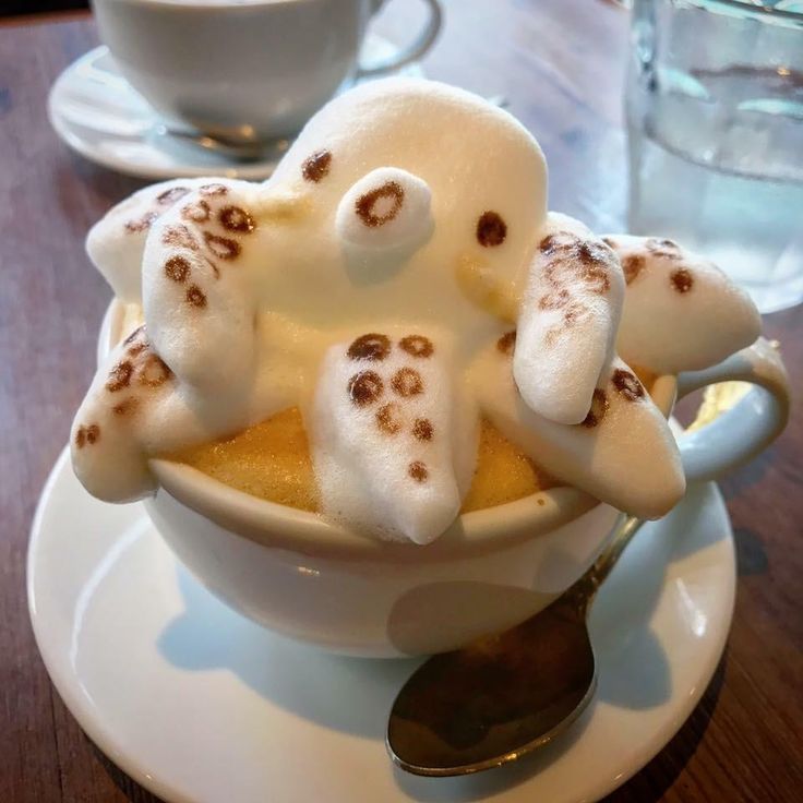 a bowl filled with marshmallows covered in googly eyes and ghost faces