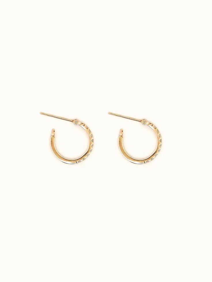 Introducing the Pave Hoop Diamond Earrings, freshly made from the studio! With hinged closures, these earrings are effortless and comfortable for everyday wear. Crafted entirely from solid gold, they’re perfect for showering, swimming, or sleeping in. Sold in singles or in pairs. Made entirely of 10K or 18K solid yellow gold. Hinge clasp hoops. Everyday effortless and comfortable to wear. Hoops dimension: Approximately 12 mm diameter | 1.5 mm band thickness. 10 x Pavé-set white round brilliant diamonds total 0.13ct each. Minimalist Everyday Diamond Earrings With Accents, Everyday Minimalist Diamond Earrings With Accents, Dainty Diamond Accented Hoop Earrings For Everyday, Dainty Hoop Earrings With Diamond Accents For Everyday, Minimalist 14k Gold Hoop Earrings With Diamond Accents, Gold Small Hoop Diamond Earrings In Minimalist Style, Everyday Gold Small Hoop Diamond Earrings, Everyday Gold Diamond Small Hoop Earrings, Everyday Small Hoop Gold Diamond Earrings