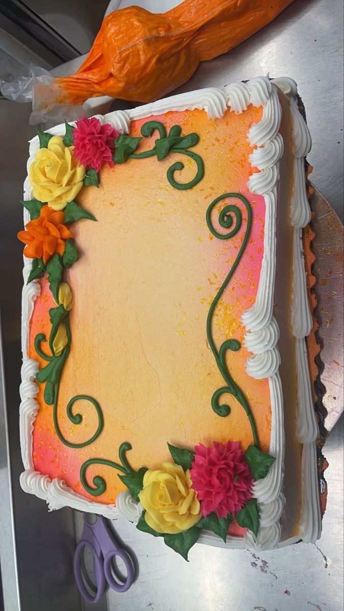 a decorated sheet cake with flowers and scissors