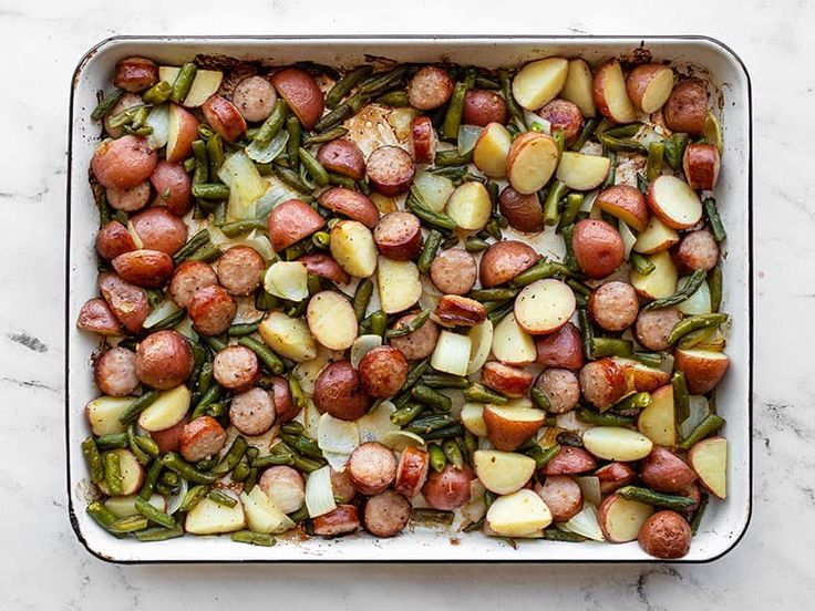 a casserole dish filled with potatoes and green beans