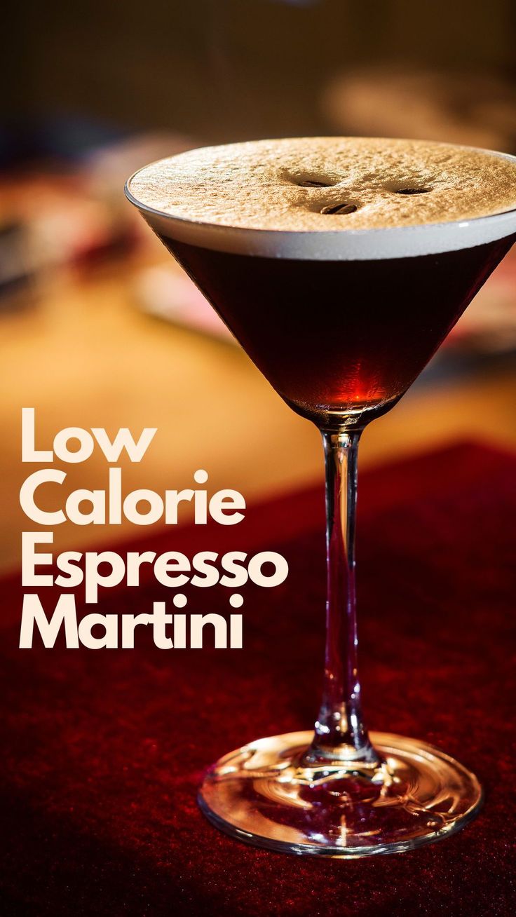 a close up of a drink in a glass on a table with the words low calorie espresso martini