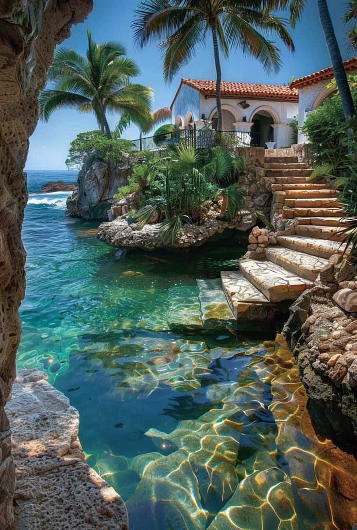 an outdoor swimming pool with steps leading to the water and palm trees in the background