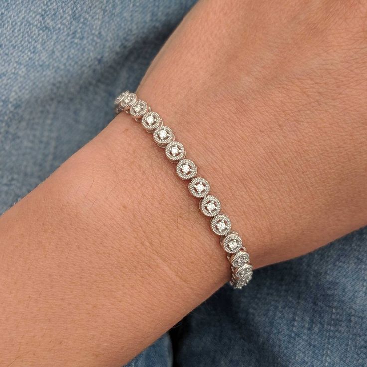 We took a classic tennis bracelet and added vintage charm with delicate milgrain detailing. The bracelet is finished with a box clasp with locking hinge for added security. This bracelet is fully customizable. If you prefer 18k gold or platinum, different dimensions, different quality diamonds or moissanites or colored gemstones, please contact us: http://etsy.me/1231fkN Details: - Solid 14k yellow or white gold - Bracelet is 7 inches in length. For different lengths, please contact us. - SI+G/H Elegant Diamond White Tennis Bracelet With Bezel Setting, Elegant Tennis Bracelet In Diamond White With Bezel Setting, Classic Bezel Setting Tennis Bracelet For Formal Occasions, Platinum Diamond Bracelet For Anniversary (jubilee Style), Anniversary Platinum Diamond Bracelet With Jubilee Style, Elegant Diamond Bracelet With Bezel Setting For Formal Occasions, Classic Silver Tennis Bracelet With Single Cut Diamonds, Classic Adjustable Tennis Bracelet With Prong Setting, Heirloom Diamond Bracelet With Round Shape