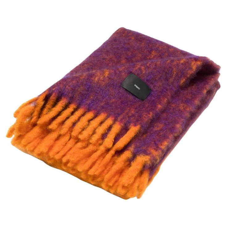 a purple and orange blanket with a black button